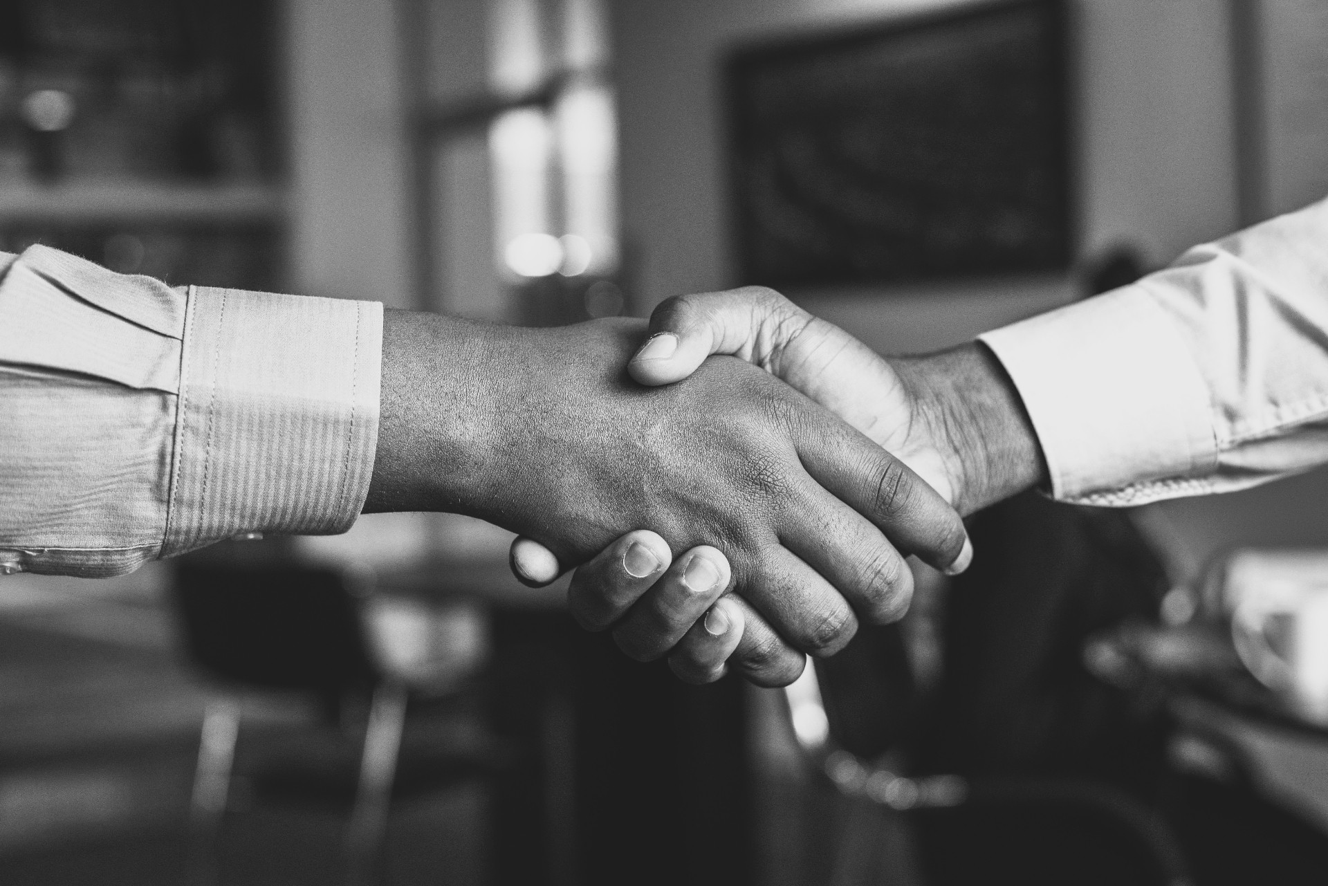 Two professionals shaking hands in an office